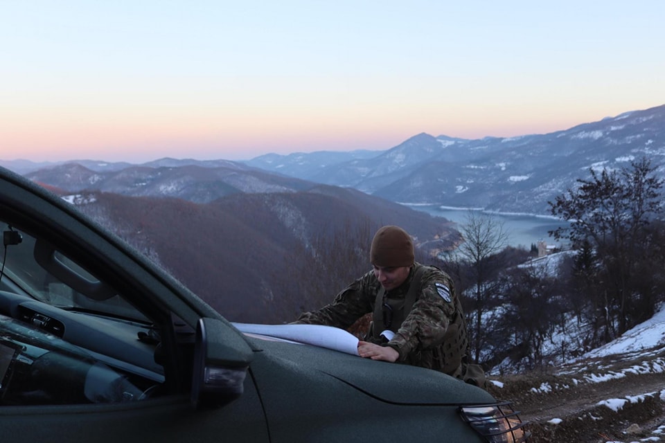 May be an image of 1 person, ski slope, road and mountain