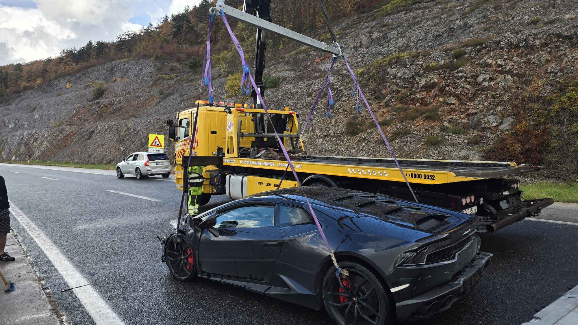 May be an image of car, road and text