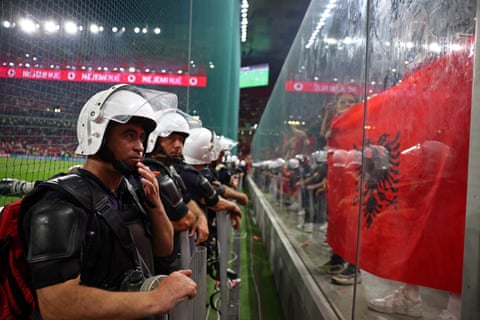 Police units stand in front of Albania’s supporters during the fraught World Cup qualifier against Serbia.